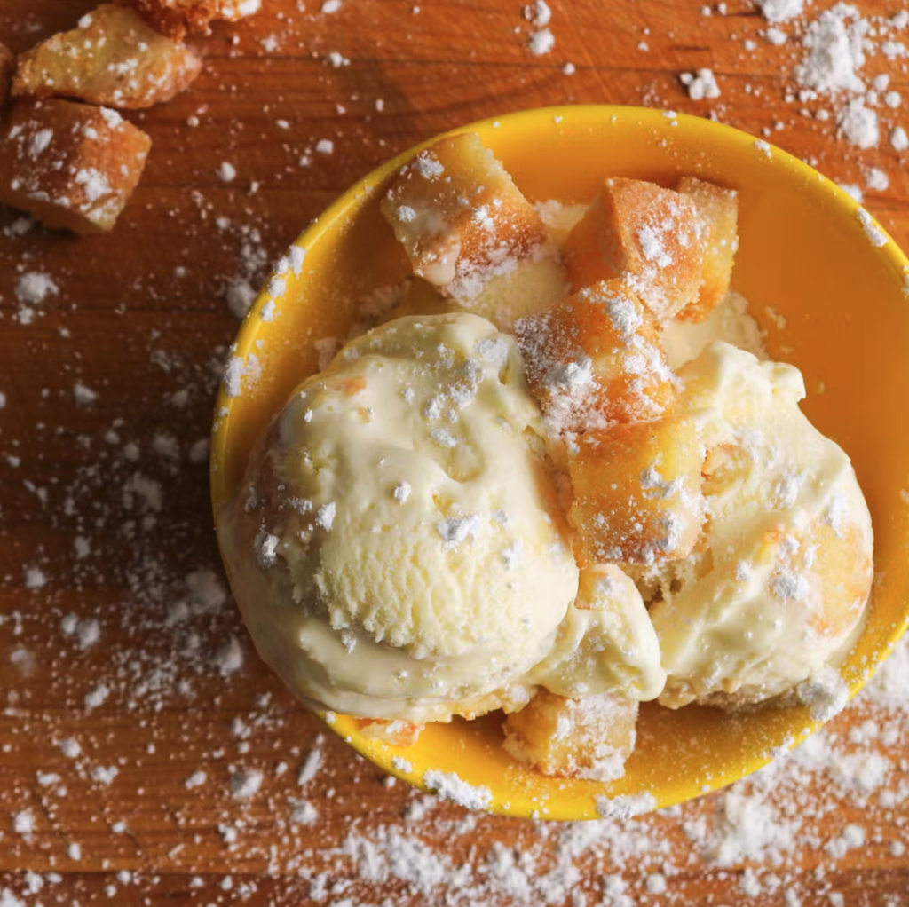 A bowl of ice cream from Clementine's Naughty and Nice Ice Cream with caramel and powdered sugar